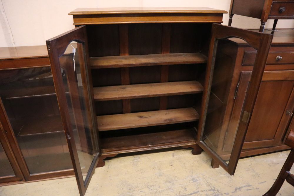 A late Victorian walnut two door glazed bookcase, width 102cm, depth 28cm, height 128cm